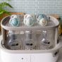 Tommee Tippee Комплект от 2 бр. ортодонтични залъгалки NIGHT TIME със светеща в тъмното дръжка, 6-18м, бяла и синя с декор луна, в кутия за стерилизиране